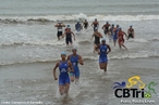 Atletas saindo do mar finalizando a etapa natao. <br> <br> Palavras-chave: esporte, triatlo, natao, ciclismo, corrida.